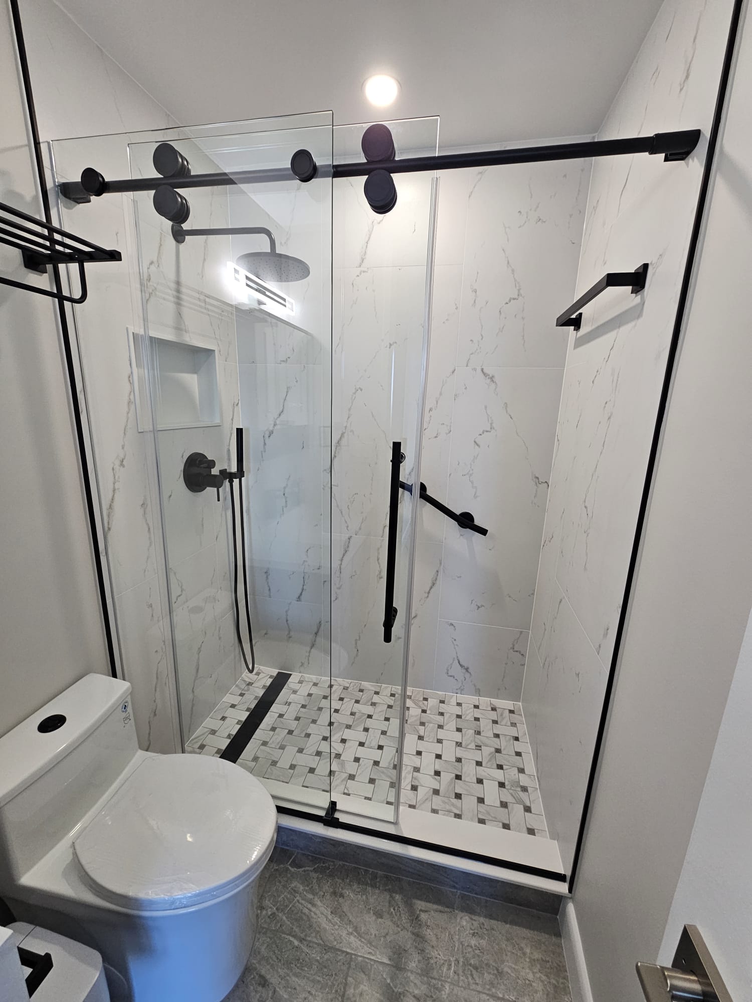 Walk-in shower with black fixtures