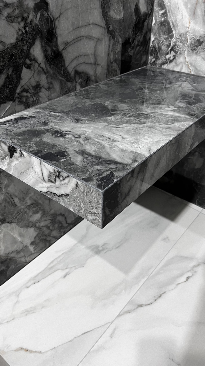 Floating marble-look shelf with mitered edges