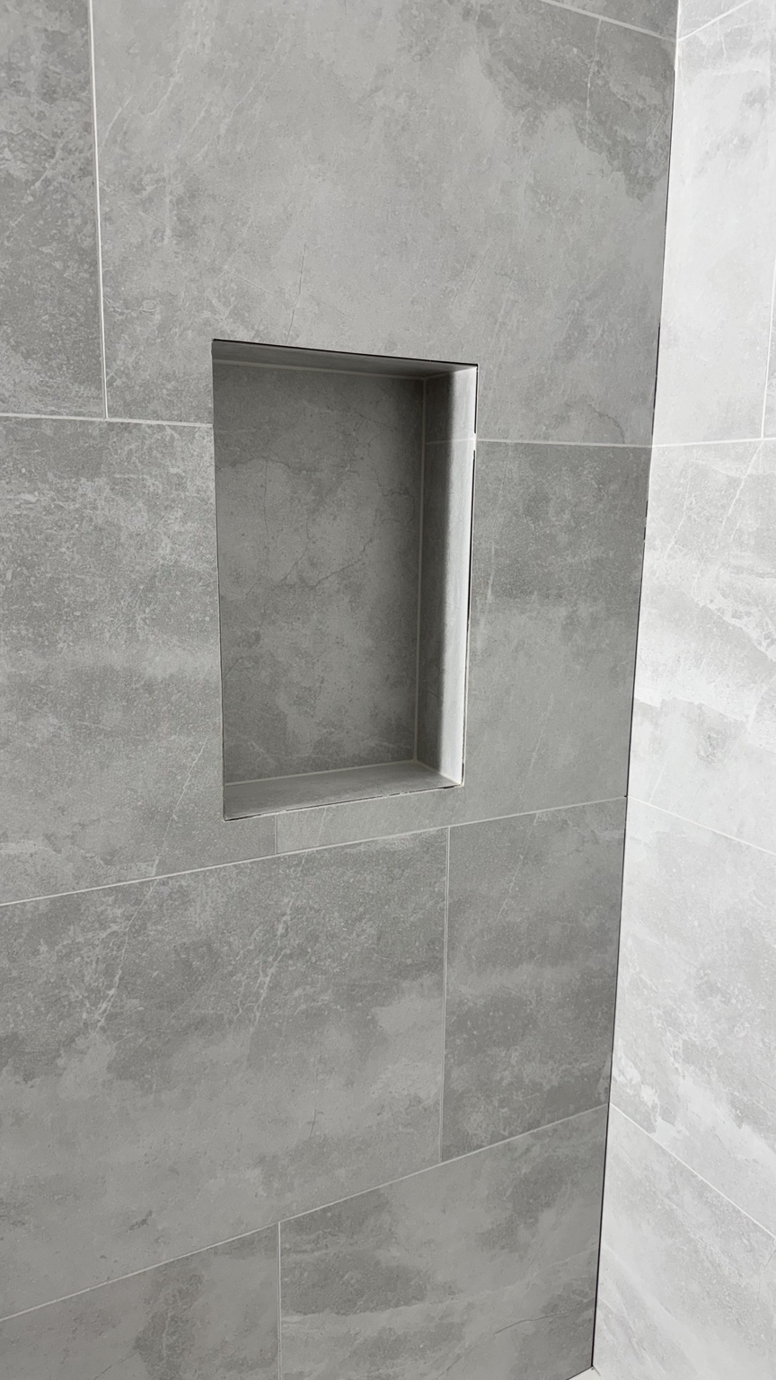 Shower niche with mitered tile edges